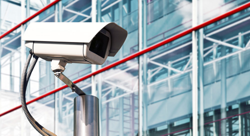 security camera outside glass and metal industrial building
