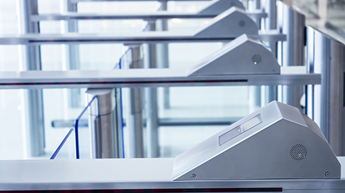 row of security card readers at entrance to office building